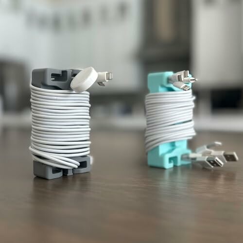Two cable organizers with neatly wound cords on a table.