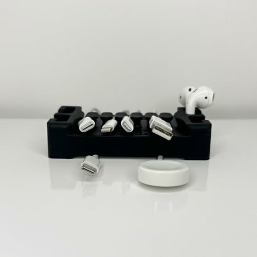 Set of charging adapters and wireless earbuds on a white surface.